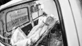A body lies in wait in an ambulance outside a cremation ground in New Delhi