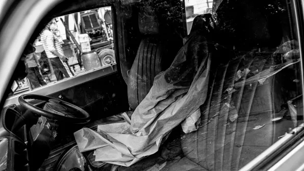 A protective robe is draped across the driver’s seat of an ambulance