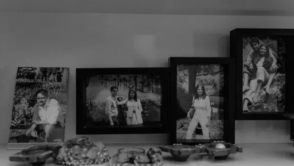 Four framed pictures of the husband and wife on a counter top