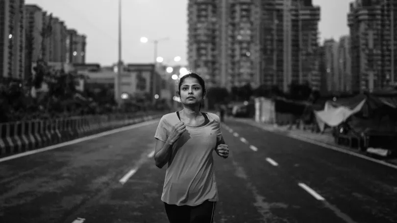 An Indian lady going for an early morning run on the road