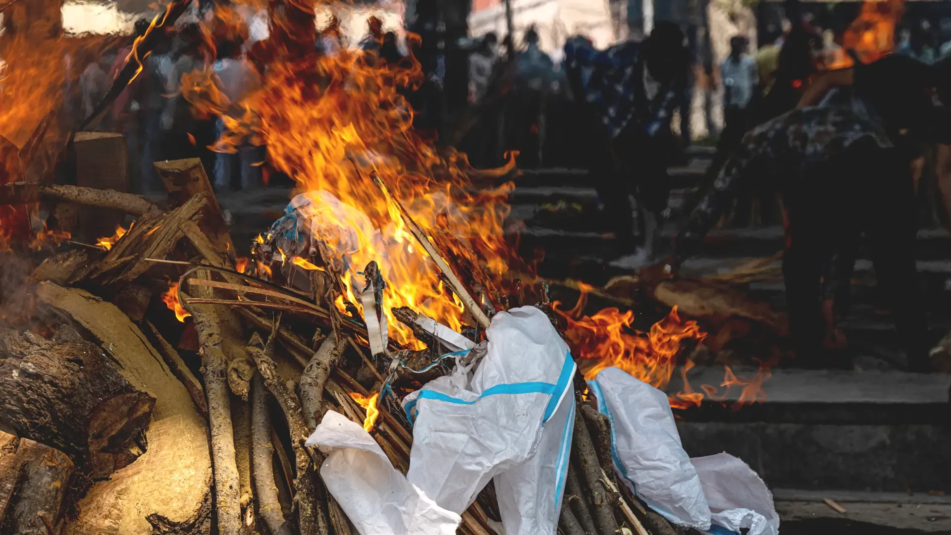 /A funeral pyre is burned with relatives' personal protective equipment at a cremation ground in New Delhi