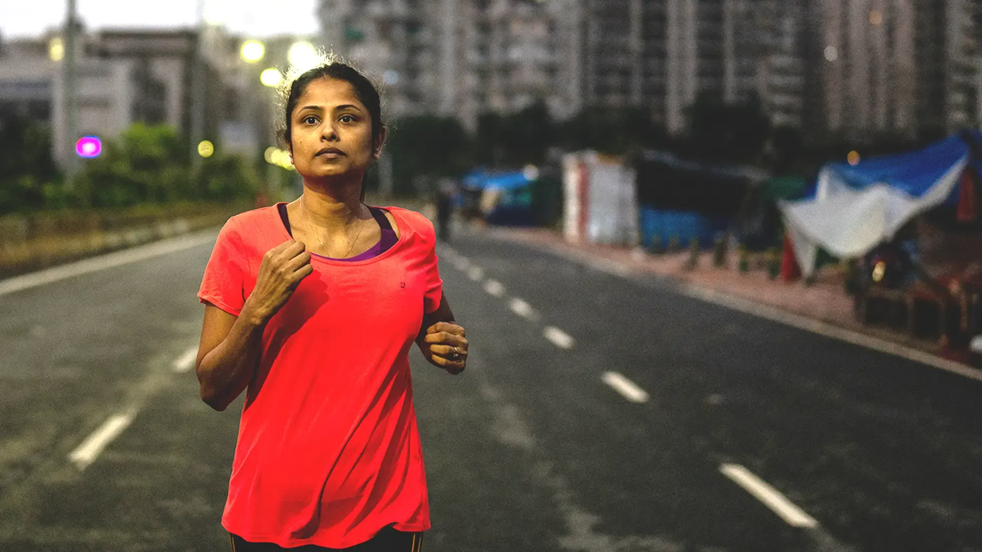 /An Indian lady going for an early morning run on the road